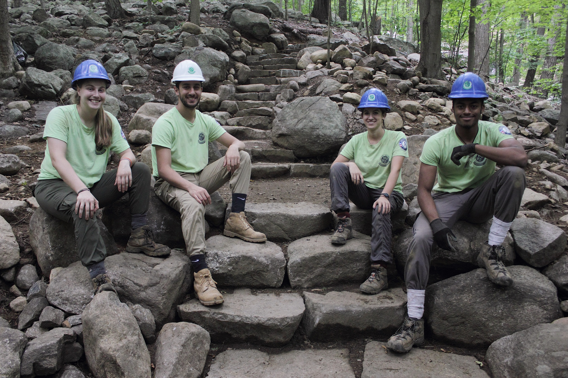 Sweet Water Trail Crew proudly sitting on their stone steps built on the Ramapo Valley County Reservation Vista Loop. Photo by Brayden Donnelly. Sweet Water Trail Crew proudly sitting on their stone steps built on the Ramapo Valley County Reservation Vista Loop. Photo by Brayden Donnelly.